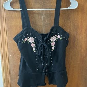 pink flower detailing, crisscross tie down the front, open at bottom front